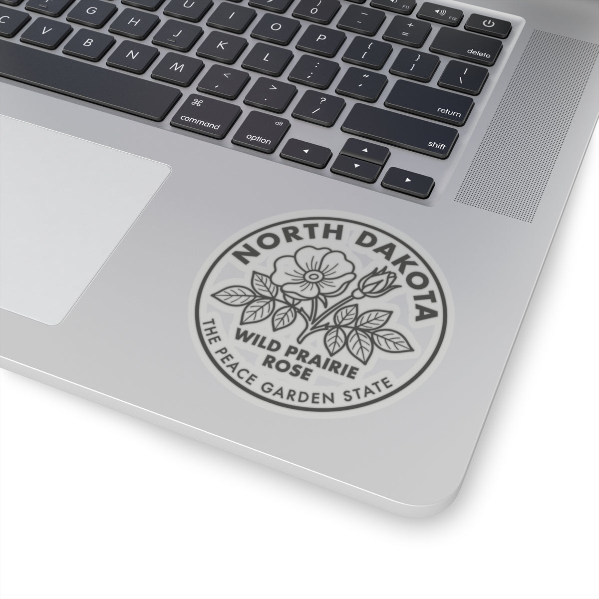Round North Dakota wild prairie rose transparent sticker on laptop lid, emblem centered