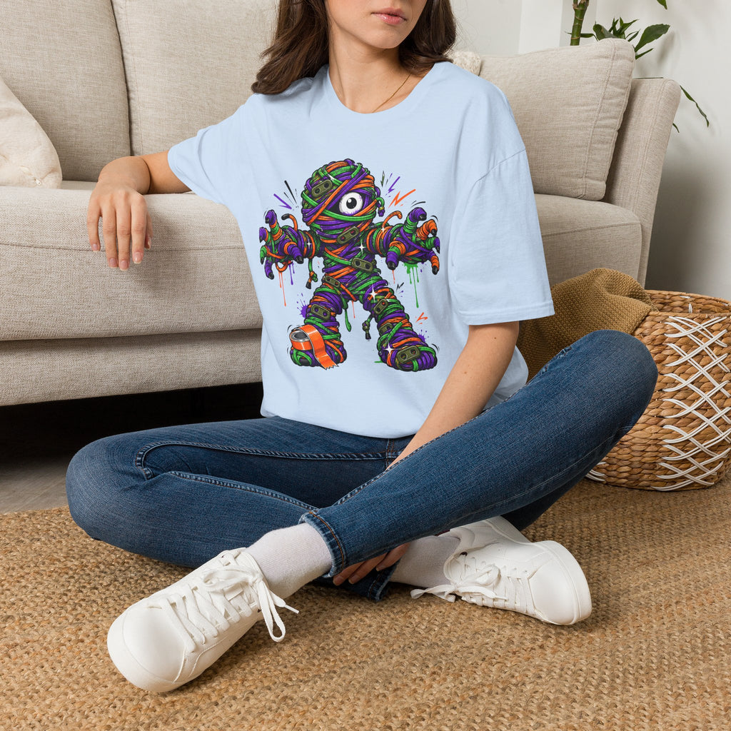 Light blue graphic mummy T-shirt with colorful wrapped monster illustration on front