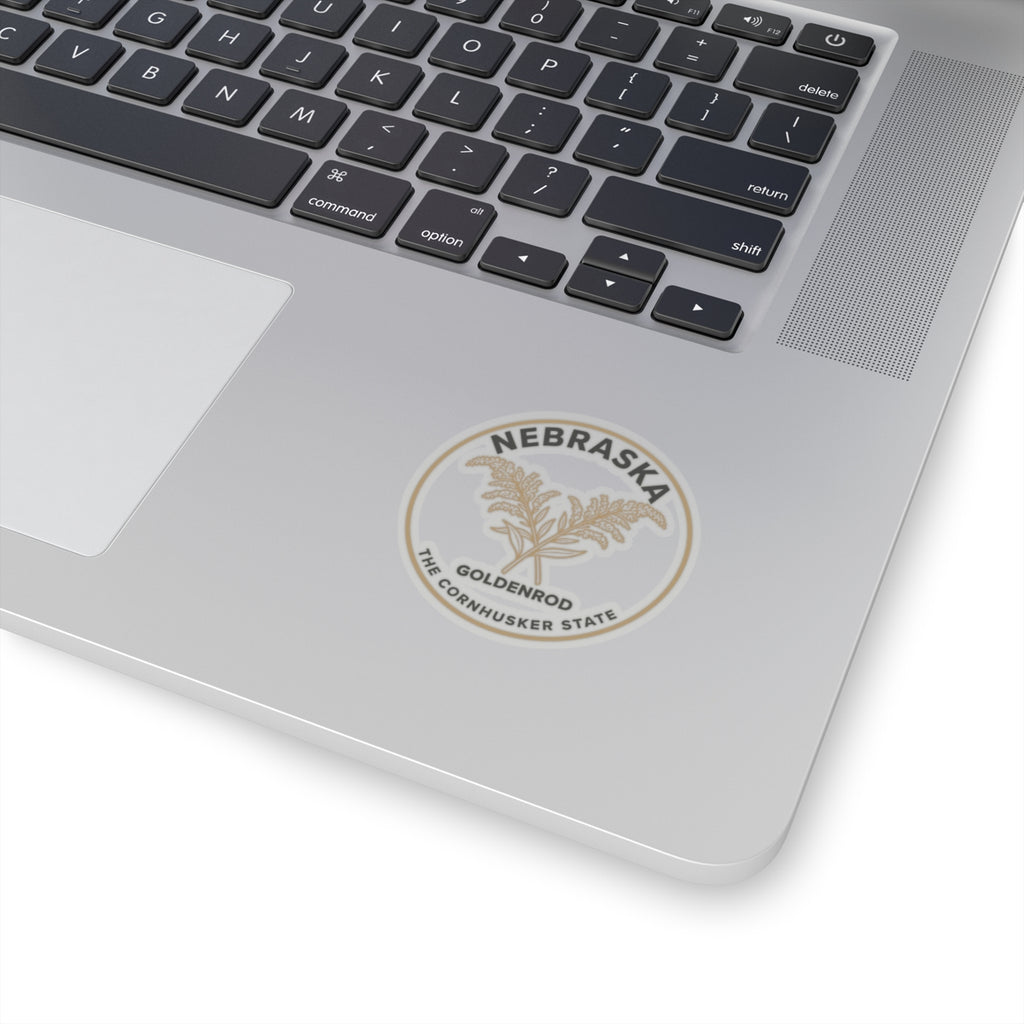 Transparent vinyl sticker placed on laptop lid with Nebraska goldenrod circular emblem