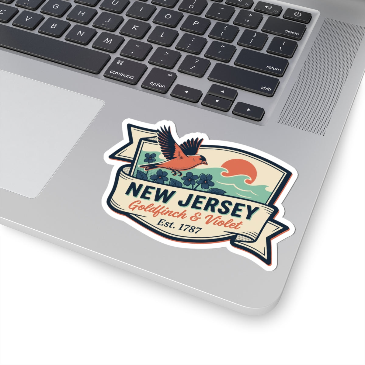 New Jersey vintage badge sticker on laptop lid, “Est. 1787” and wave graphic.