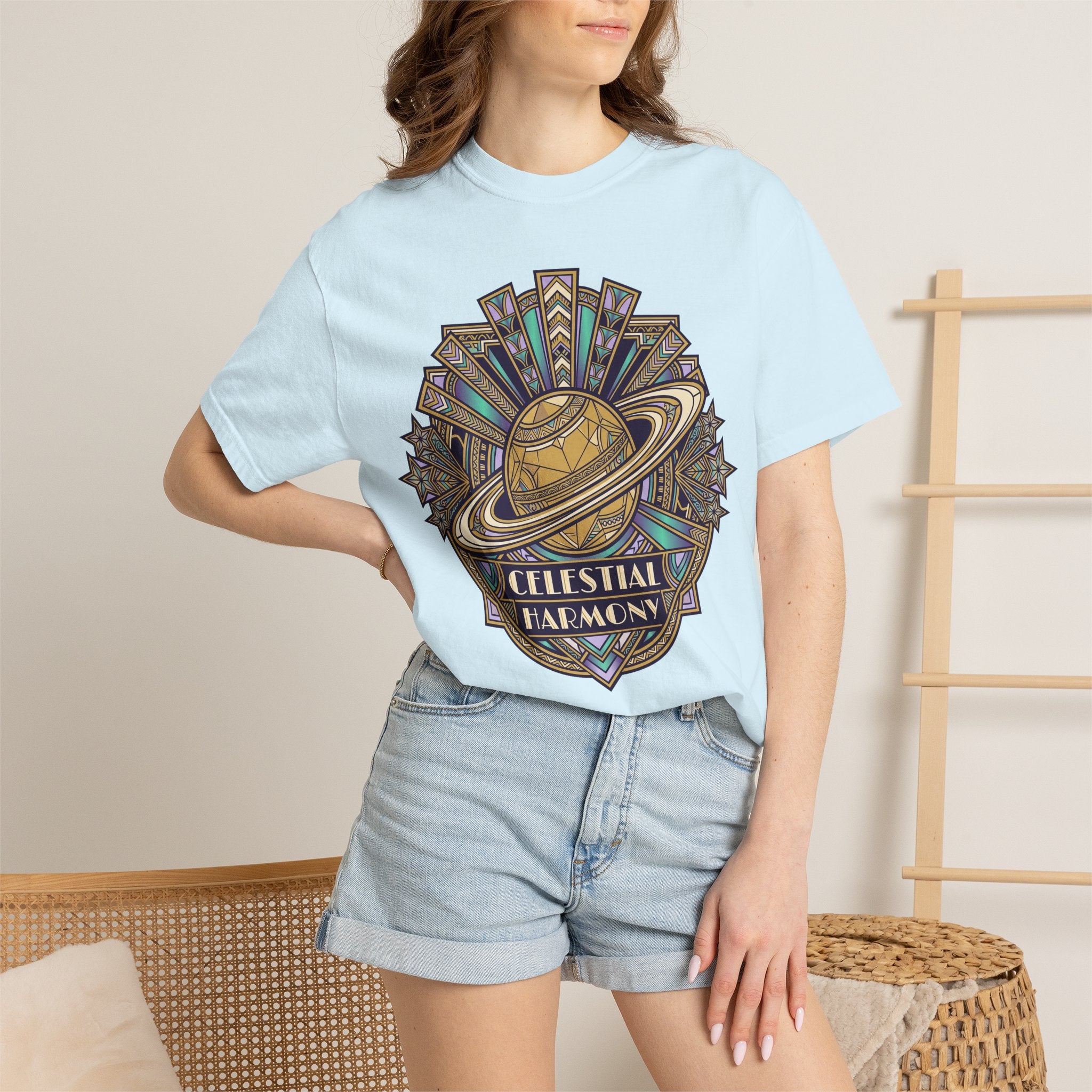 Celestial graphic T-shirt in light blue with “CELESTIAL HARMONY” text.