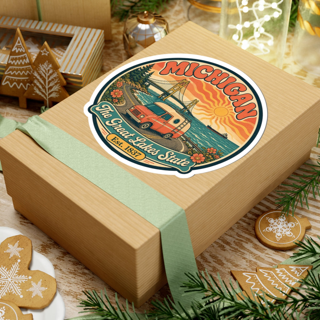Michigan round travel sticker on gift box top, camper van and bridge scene, Est. 1837.