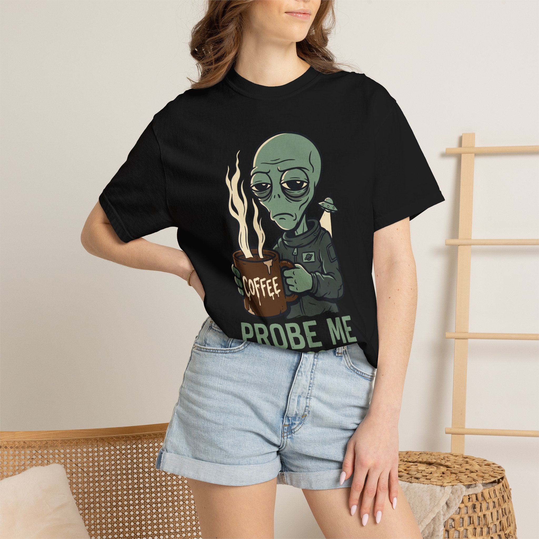 Black alien coffee T-shirt on model, 'PROBE ME' text under alien holding coffee