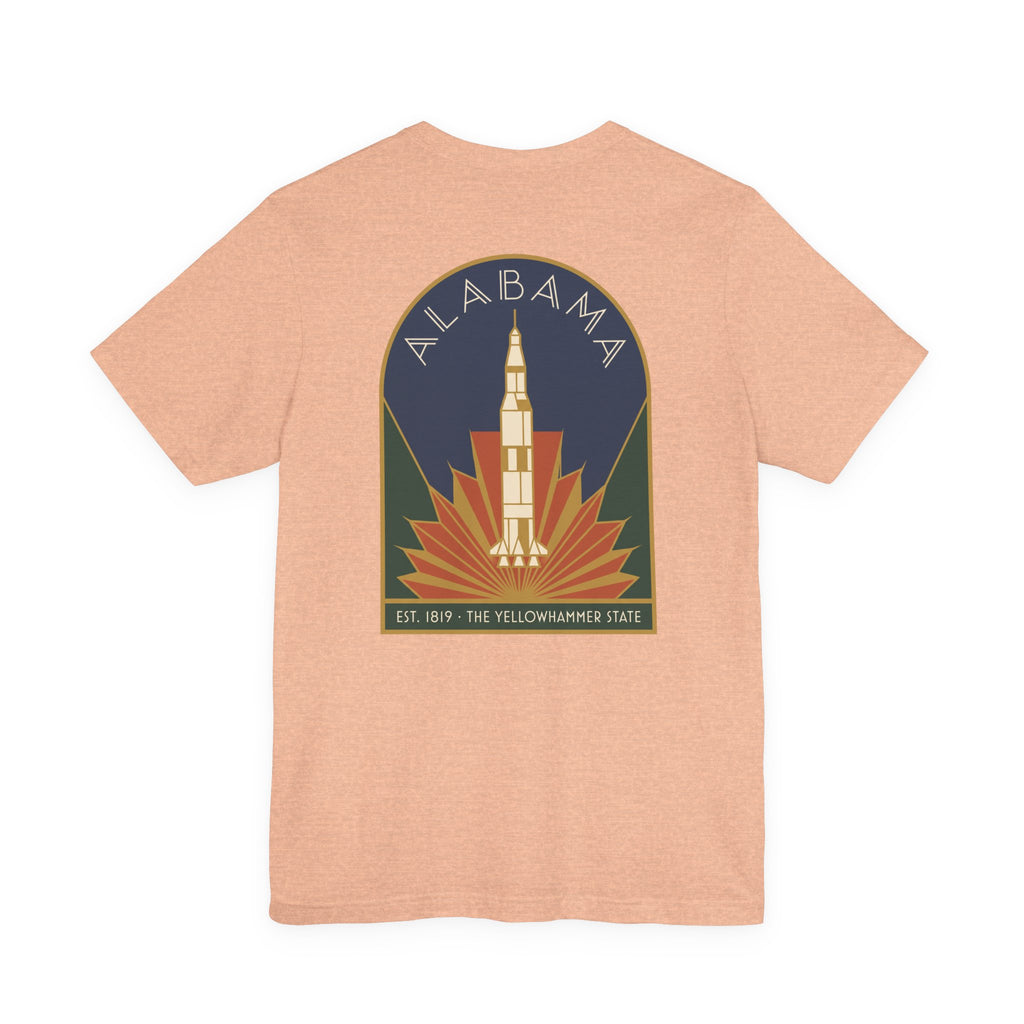 Peach T-shirt with Alabama rocket emblem graphic centered on back