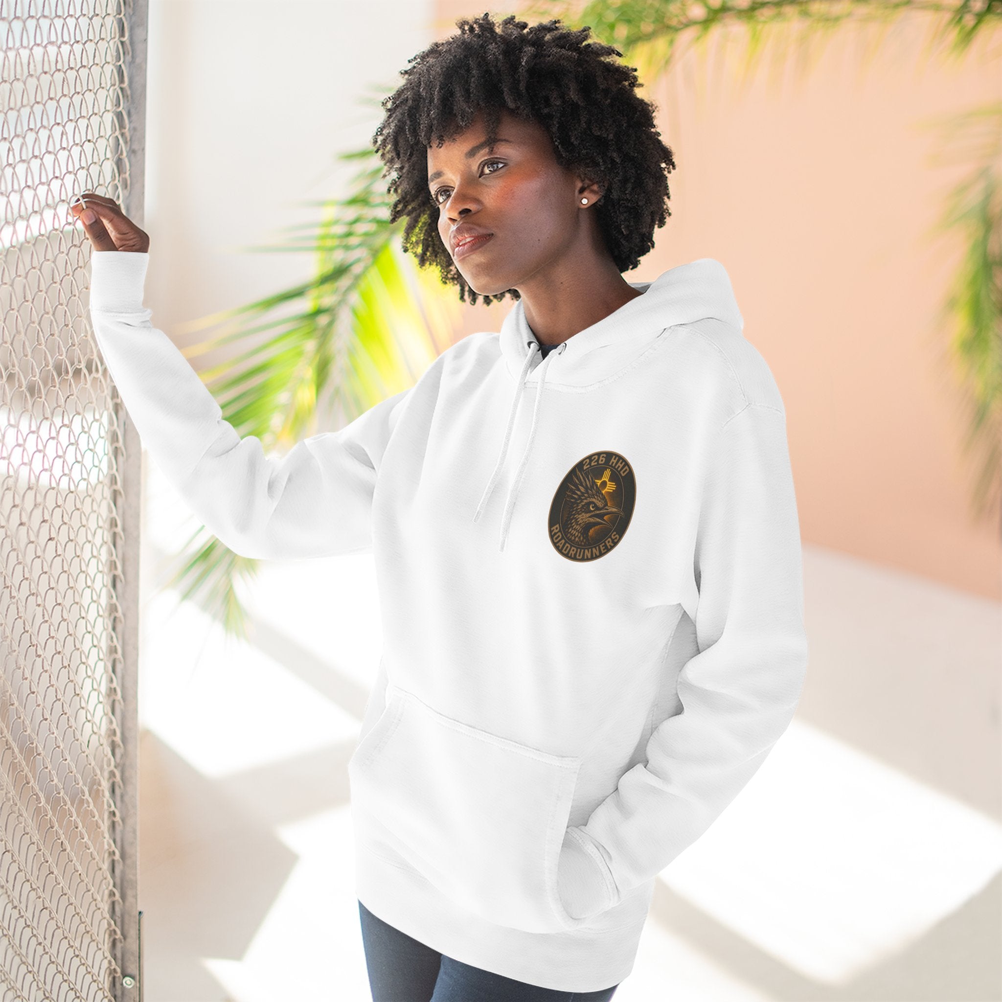 White pullover hoodie on model, hood and chest patch with front pocket