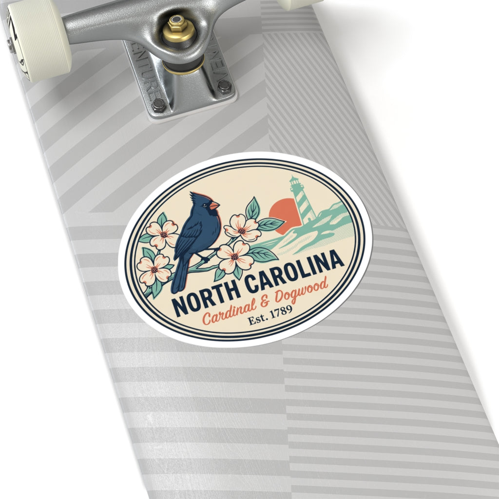North Carolina state badge sticker on a light gray notebook, featuring cardinal, flowers, lighthouse