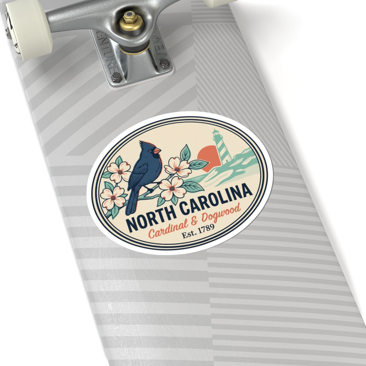 North Carolina state badge sticker on a light gray notebook, featuring cardinal, flowers, lighthouse