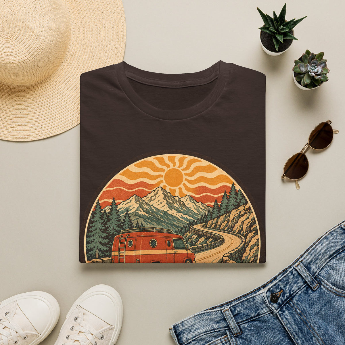 Unisex T-shirt in dark brown with crew neck and mountain sunset van graphic on front.