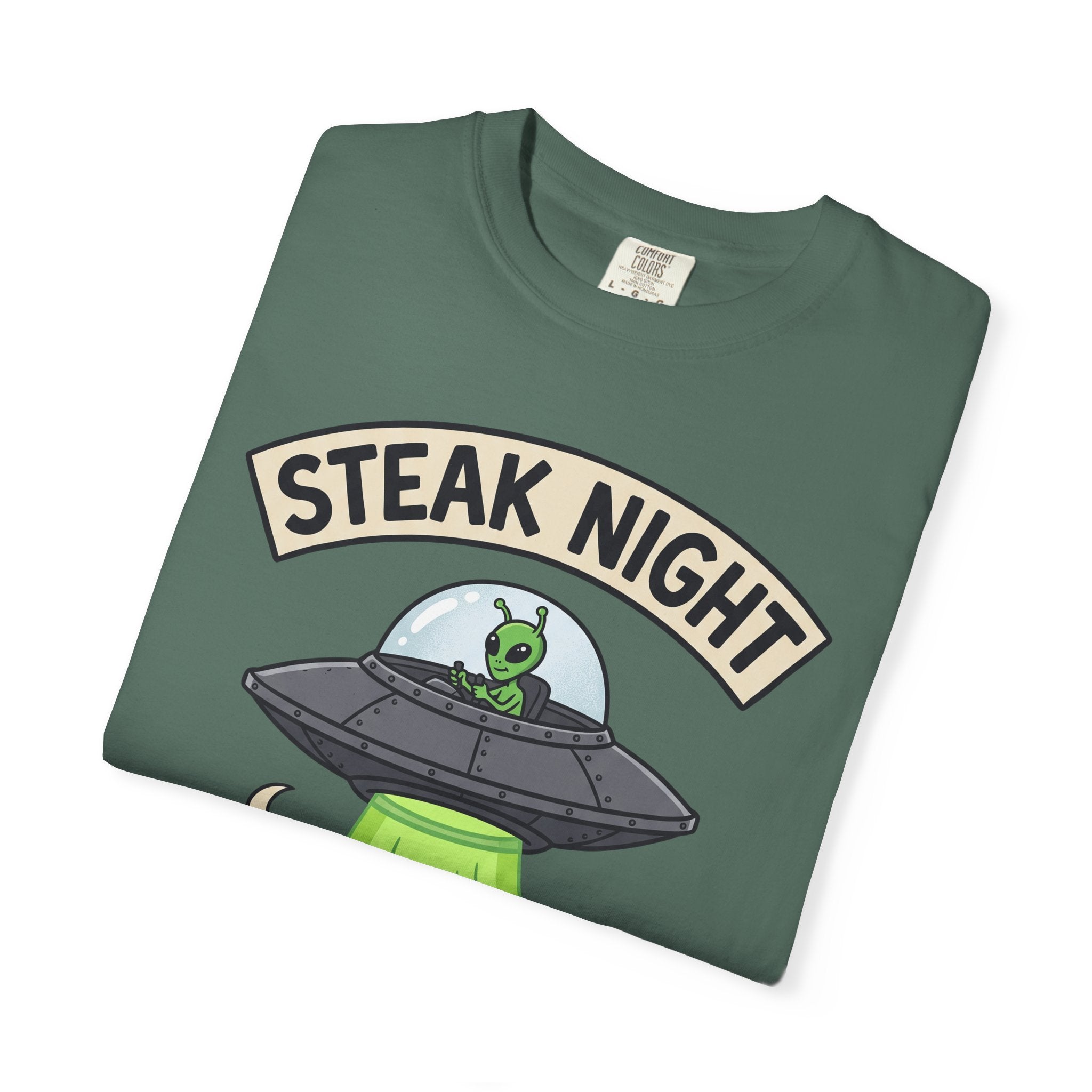 Forest green graphic T-shirt with 'STEAK NIGHT' UFO and alien cow illustration.