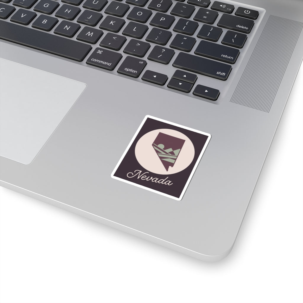 Square kiss-cut Nevada decal with desert mountain silhouette and small Nevada script on laptop