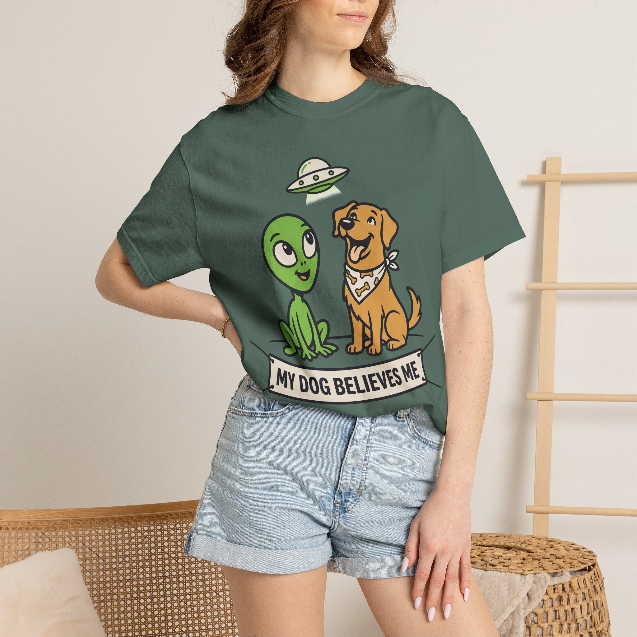 Green T-shirt with alien and dog graphic and 'MY DOG BELIEVES ME' text