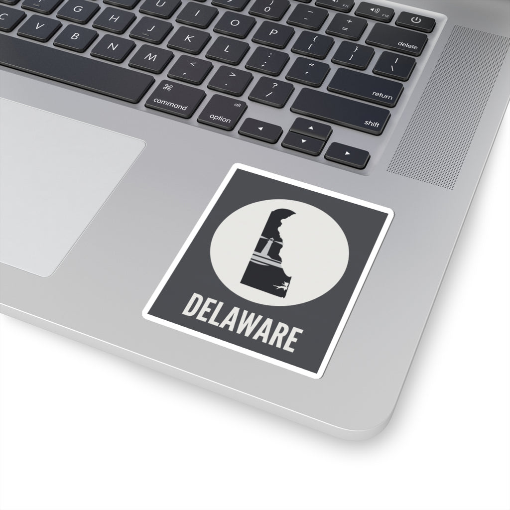 Delaware state silhouette sticker on laptop lid, white circle badge and DELAWARE text