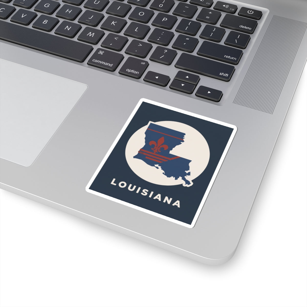 Louisiana sticker on laptop lid with state map, fleur-de-lis, and "LOUISIANA" lettering