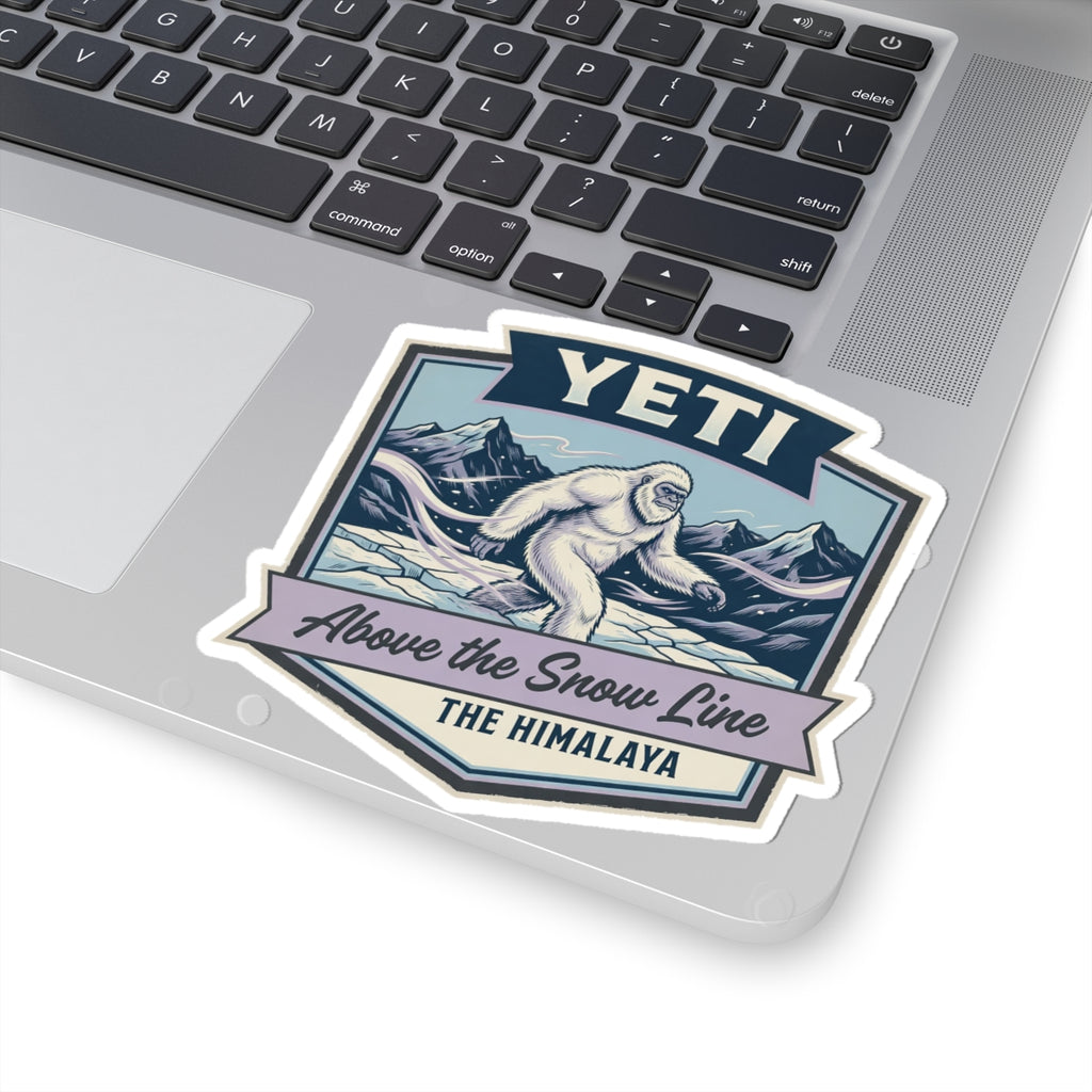 YETI die-cut sticker on laptop showing Himalayan sasquatch above the snow line