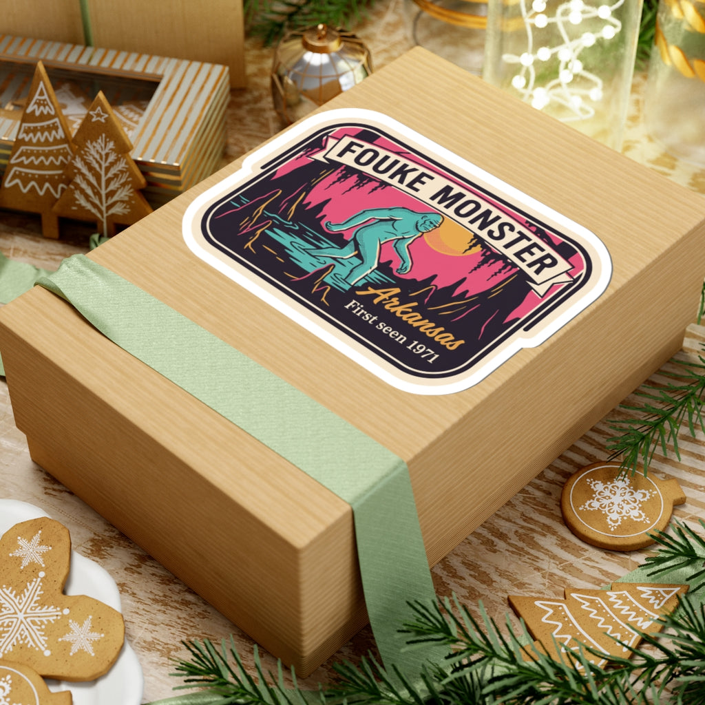 Fouke Monster Arkansas sticker on wrapped present with teal ribbon and holiday decor