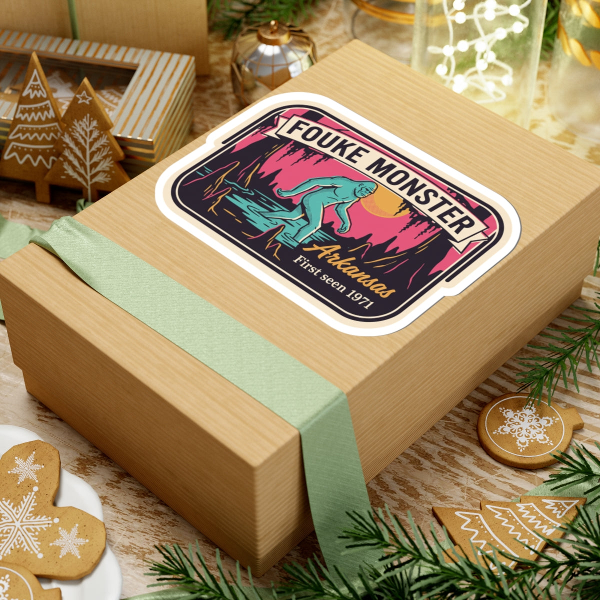 Fouke Monster Arkansas sticker on wrapped present with teal ribbon and holiday decor