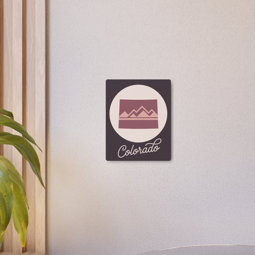Small mauve Colorado mountain metal wall art with cream circle and cursive "Colorado"