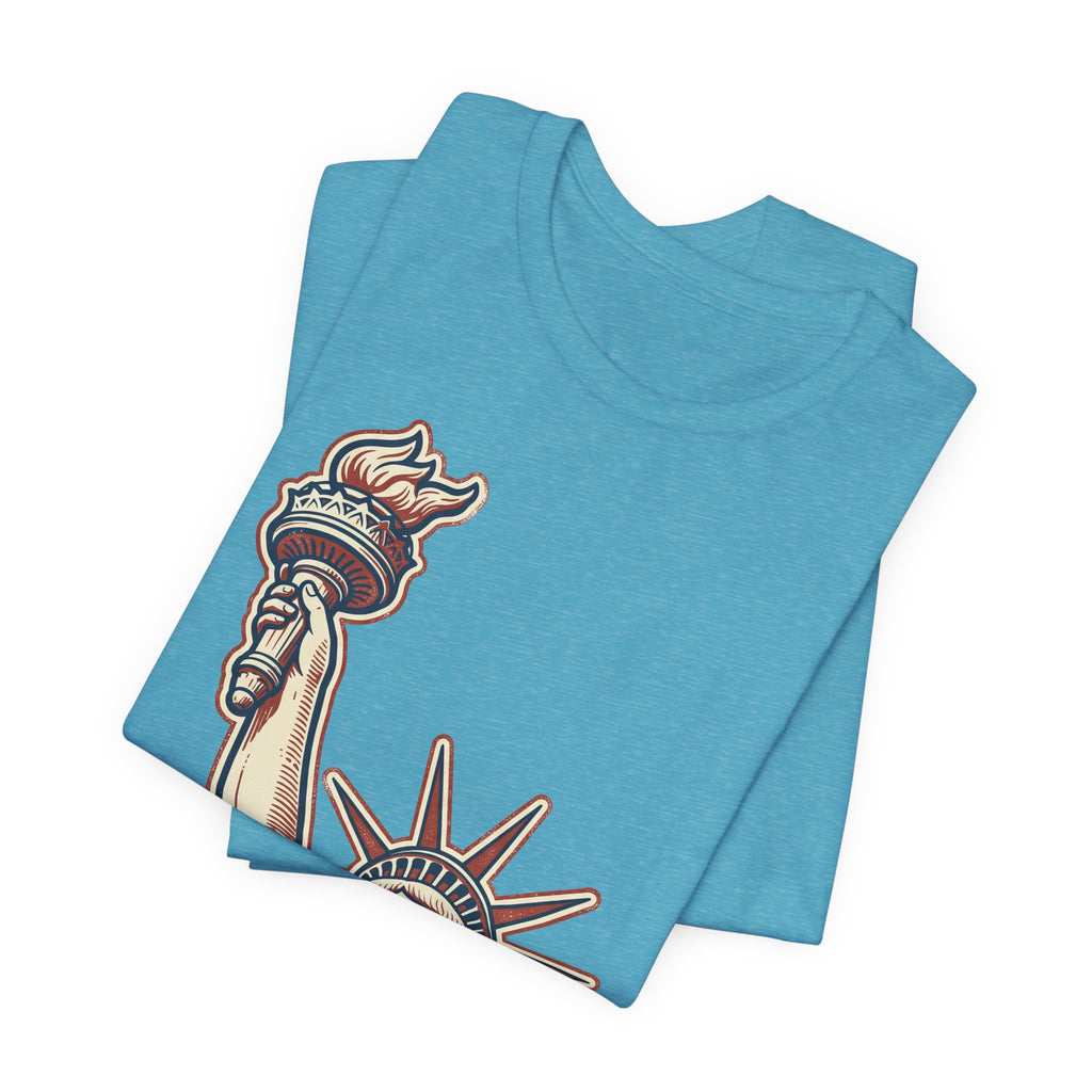 Light blue crewneck graphic tee with Statue of Liberty style illustration on front.