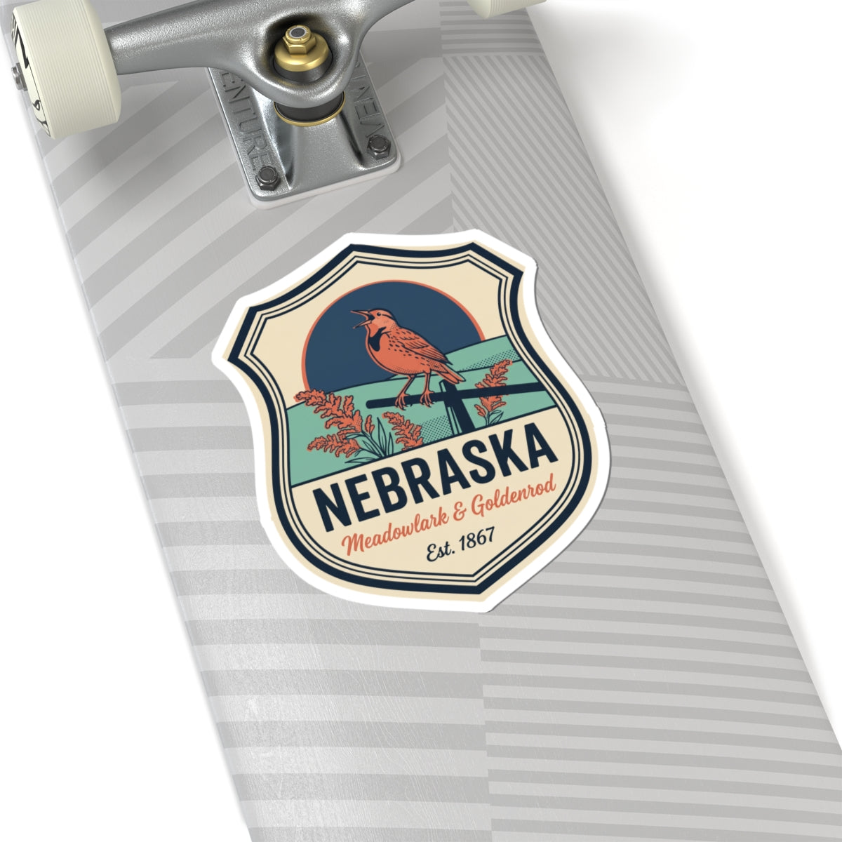 Nebraska vintage badge sticker on a gray surface, meadowlark & goldenrod, Est. 1867