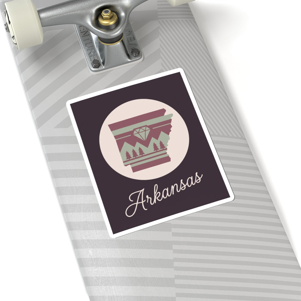 Arkansas state silhouette vinyl decal on surface, circular badge with maroon stripes