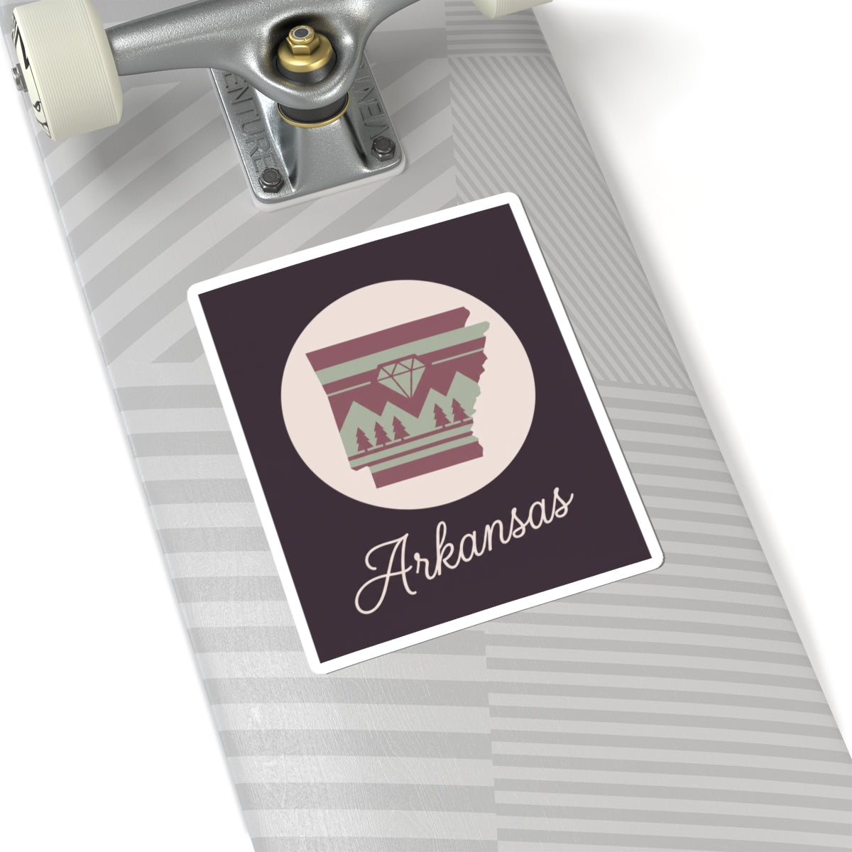 Arkansas state silhouette vinyl decal on surface, circular badge with maroon stripes