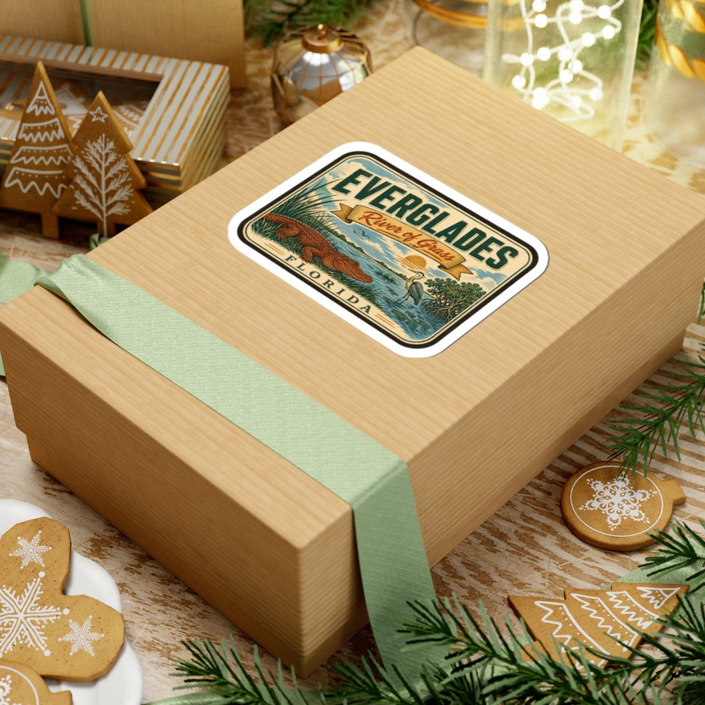 Everglades River of Grass Florida travel sticker on a wrapped gift box with green ribbon.