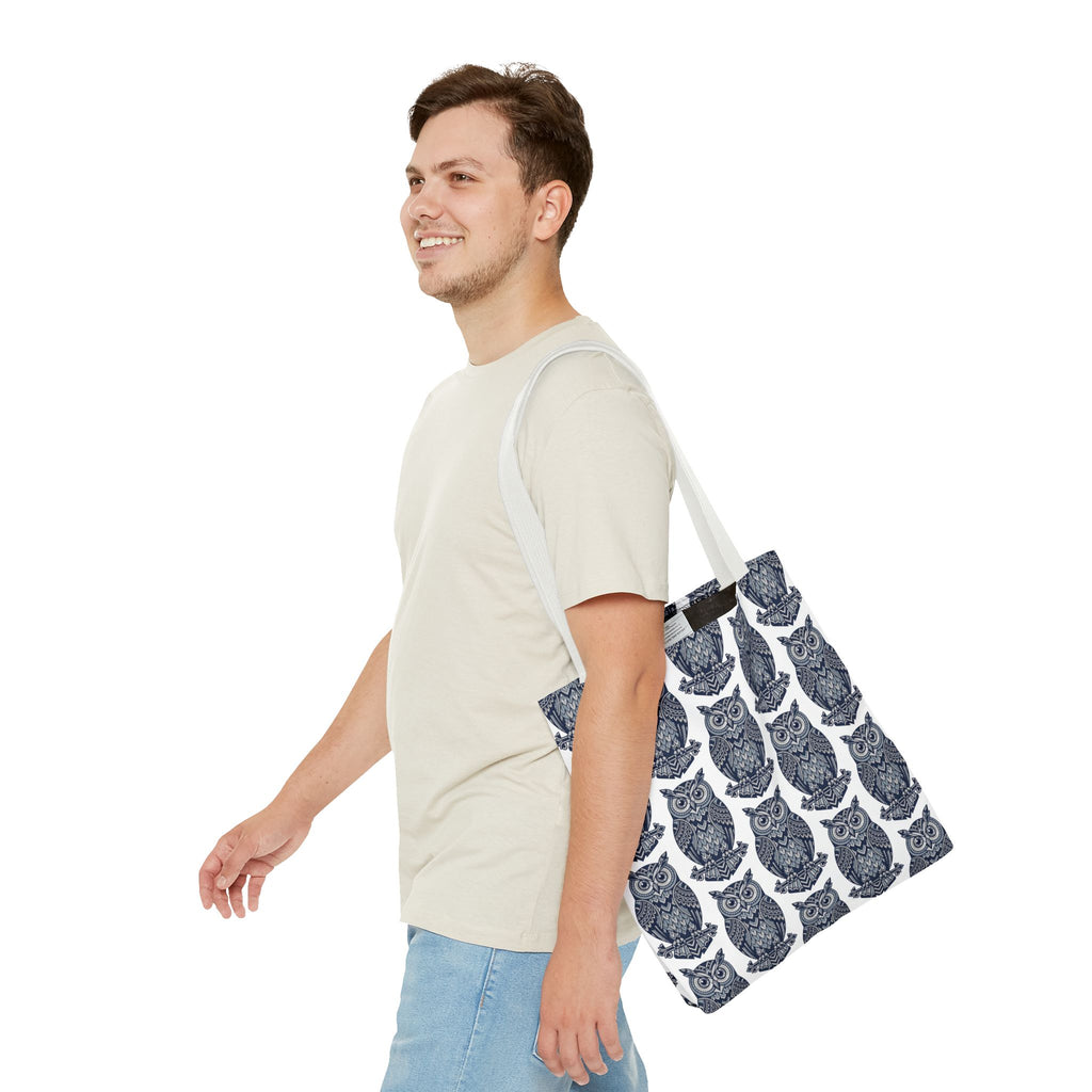Tote bag with navy owl pattern and white handles, angled side view