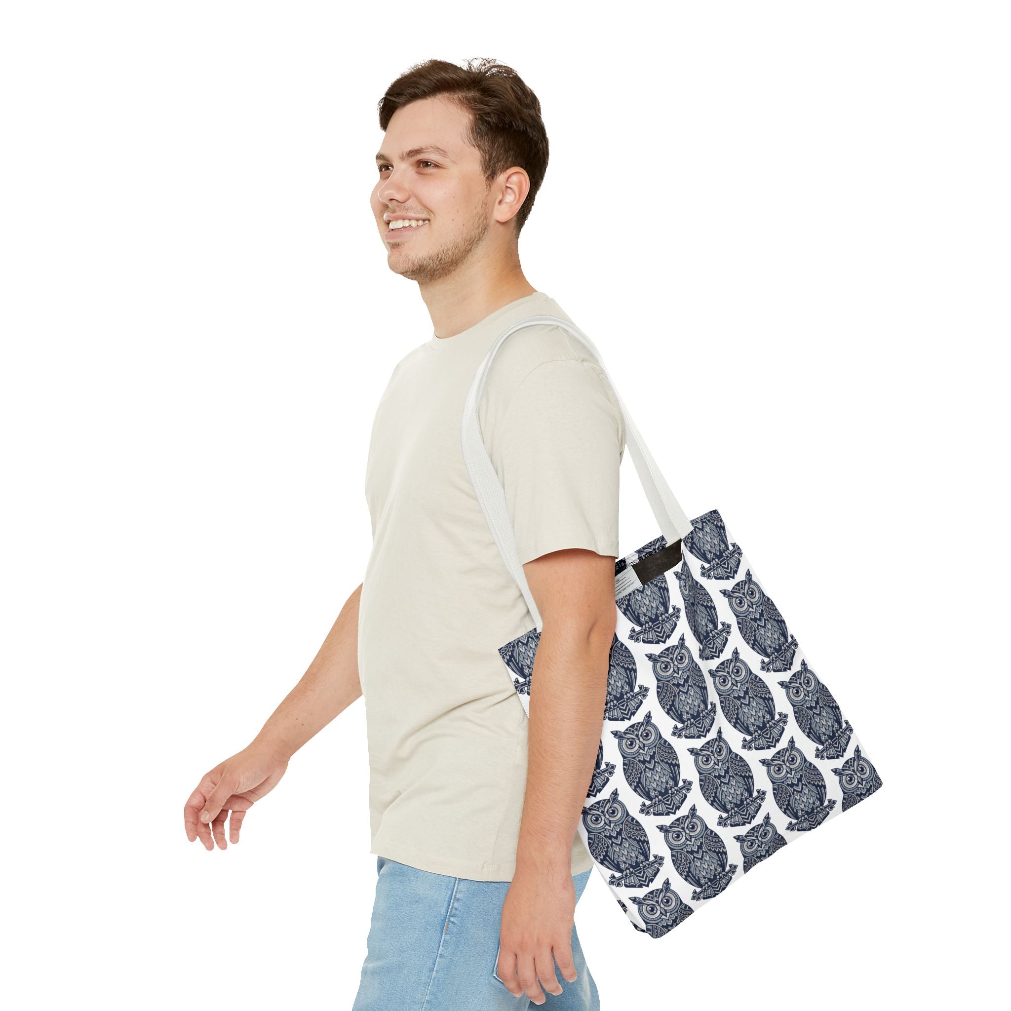 Tote bag with navy owl pattern and white handles, angled side view