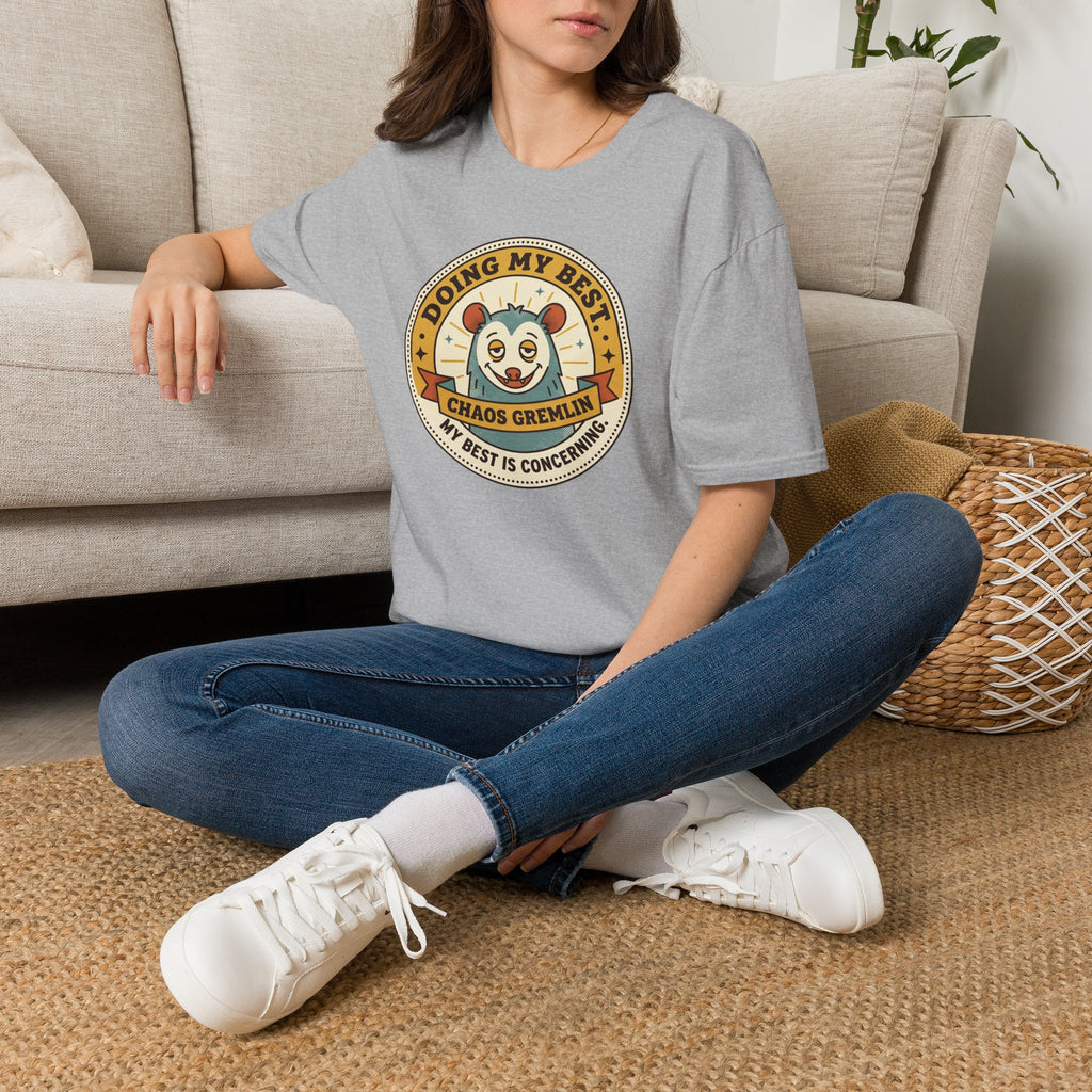 Light gray crewneck T-shirt with circular cartoon gremlin logo graphic on chest