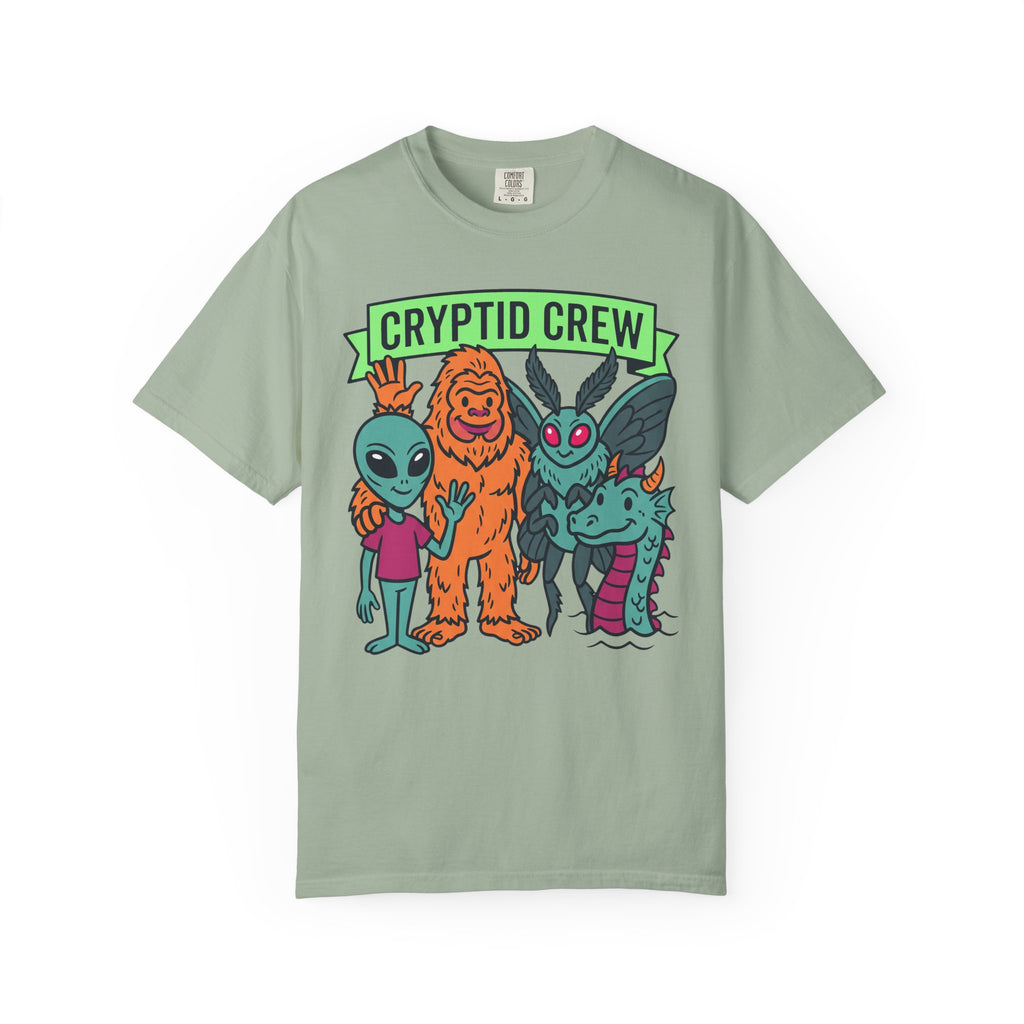 Sage green crew neck t-shirt with “CRYPTID CREW” cartoon cryptid group graphic