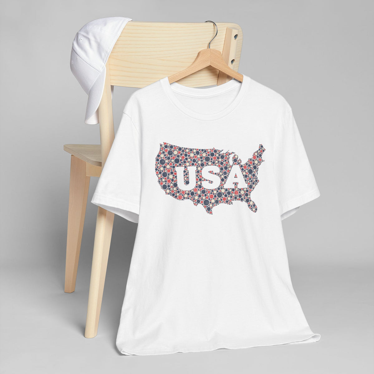 Cream T-shirt with colorful USA outline graphic on the front