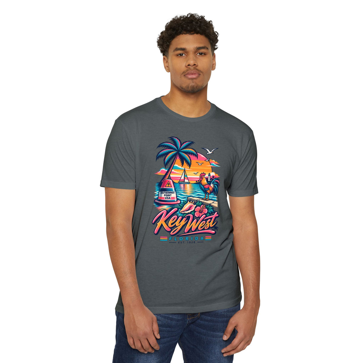 Charcoal Key West tropical sunset T-shirt worn by a model; palm tree and flamingo front graphic