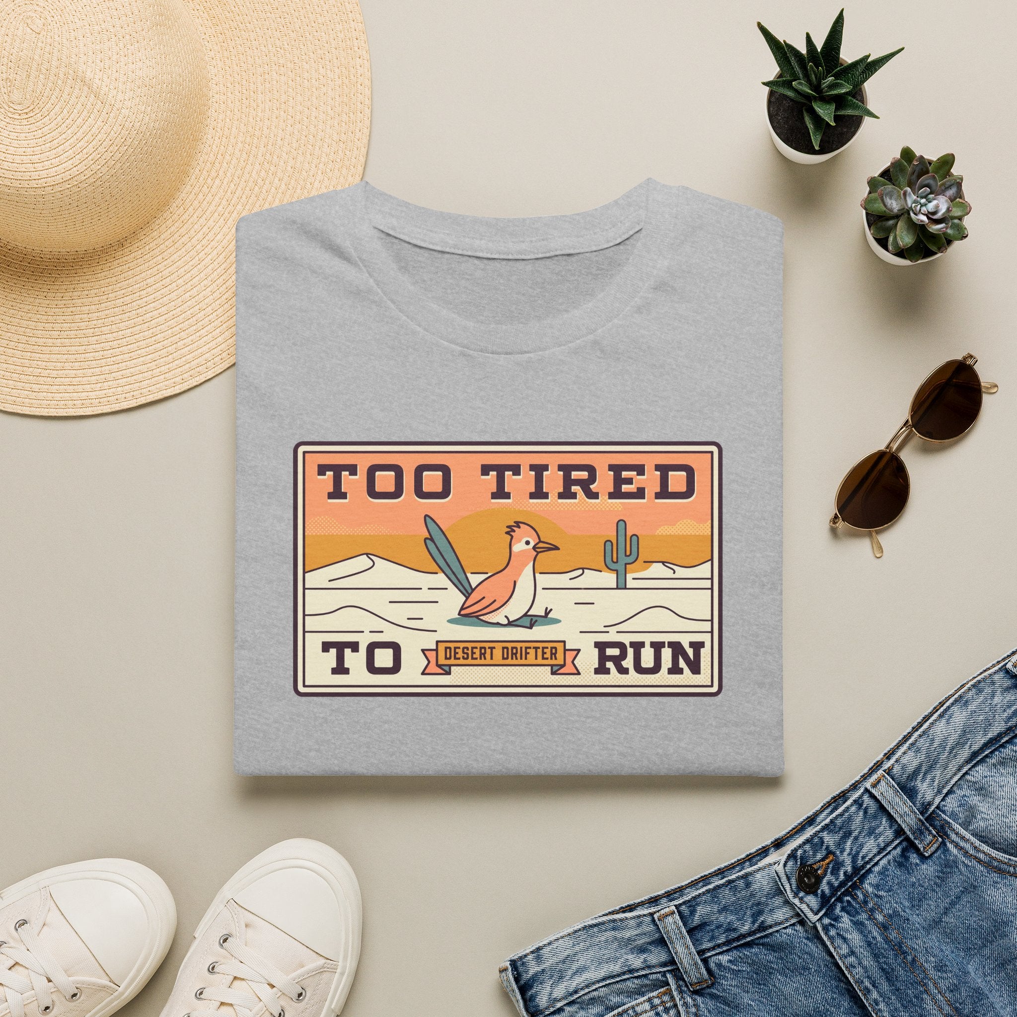 Light gray crew-neck T-shirt with Too Tired To Run desert roadrunner graphic