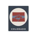 Colorado metal art sign with circular mountain flag graphic and “COLORADO” text