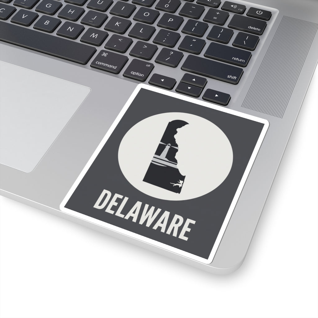 Delaware state silhouette sticker on laptop, dark badge with white circle and DELAWARE text