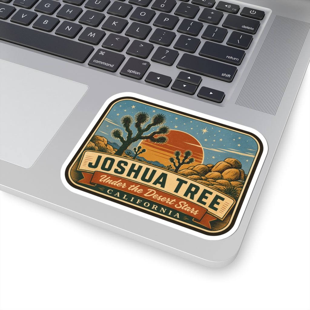 Joshua Tree National Park sticker on laptop showing crescent sunset, rocks, and desert text art.