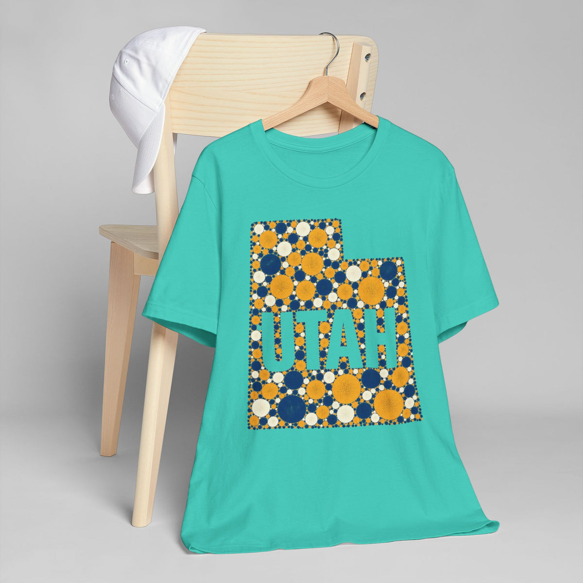 Teal T-shirt with blue and gold polka-dot Utah map outline and lettering graphic