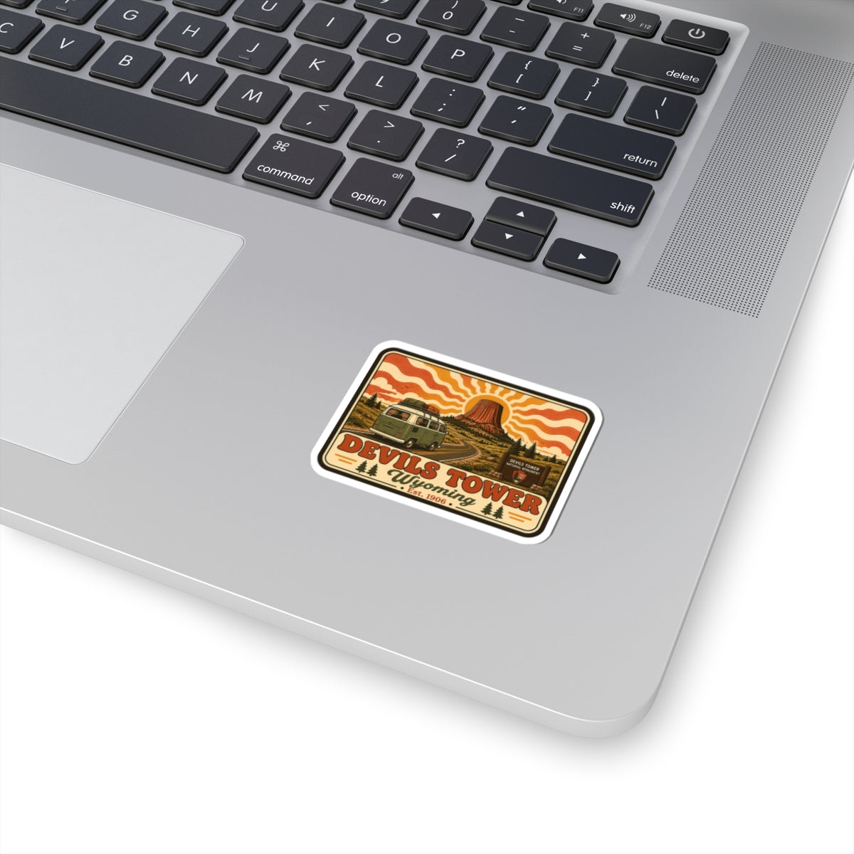 Devils Tower National Monument kiss-cut sticker with desert landscape and tower illustration