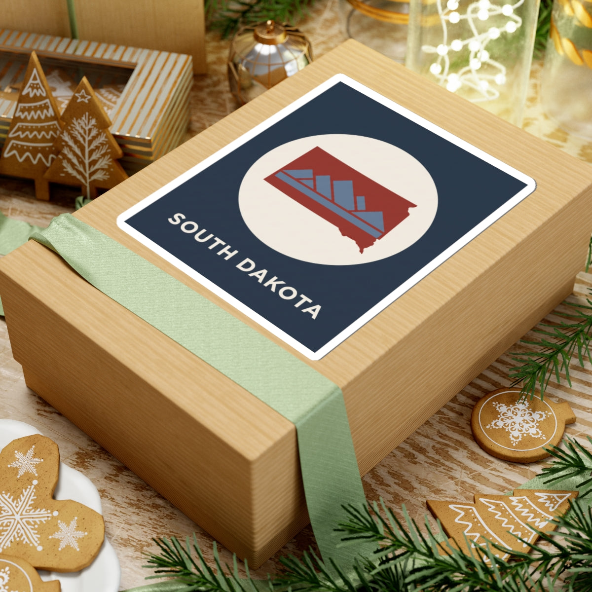 South Dakota map badge sticker on wrapped gift box with navy square backing and white circle