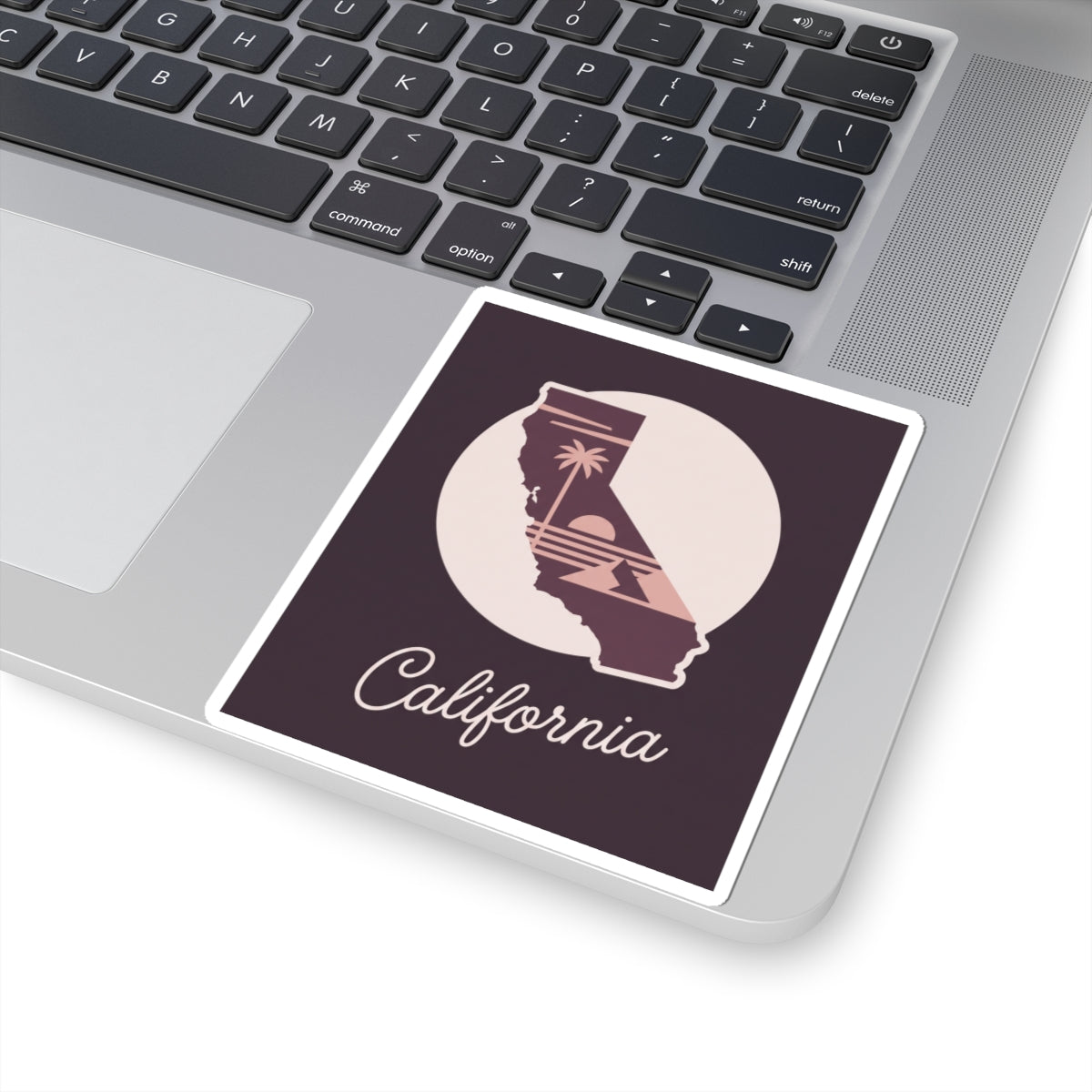 California mauve state outline sticker displayed on a laptop, “California” script visible
