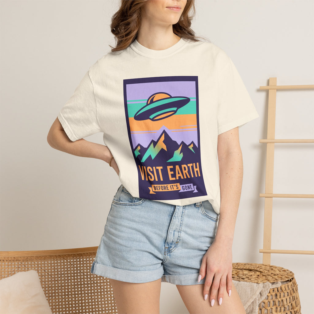 White T-shirt on model with 'Visit Earth' framed UFO poster graphic
