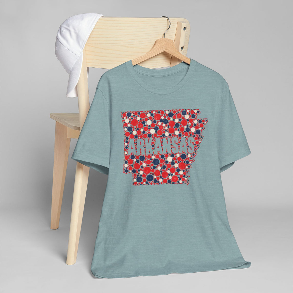 Light teal T-shirt with red and blue floral dot Arkansas outline graphic