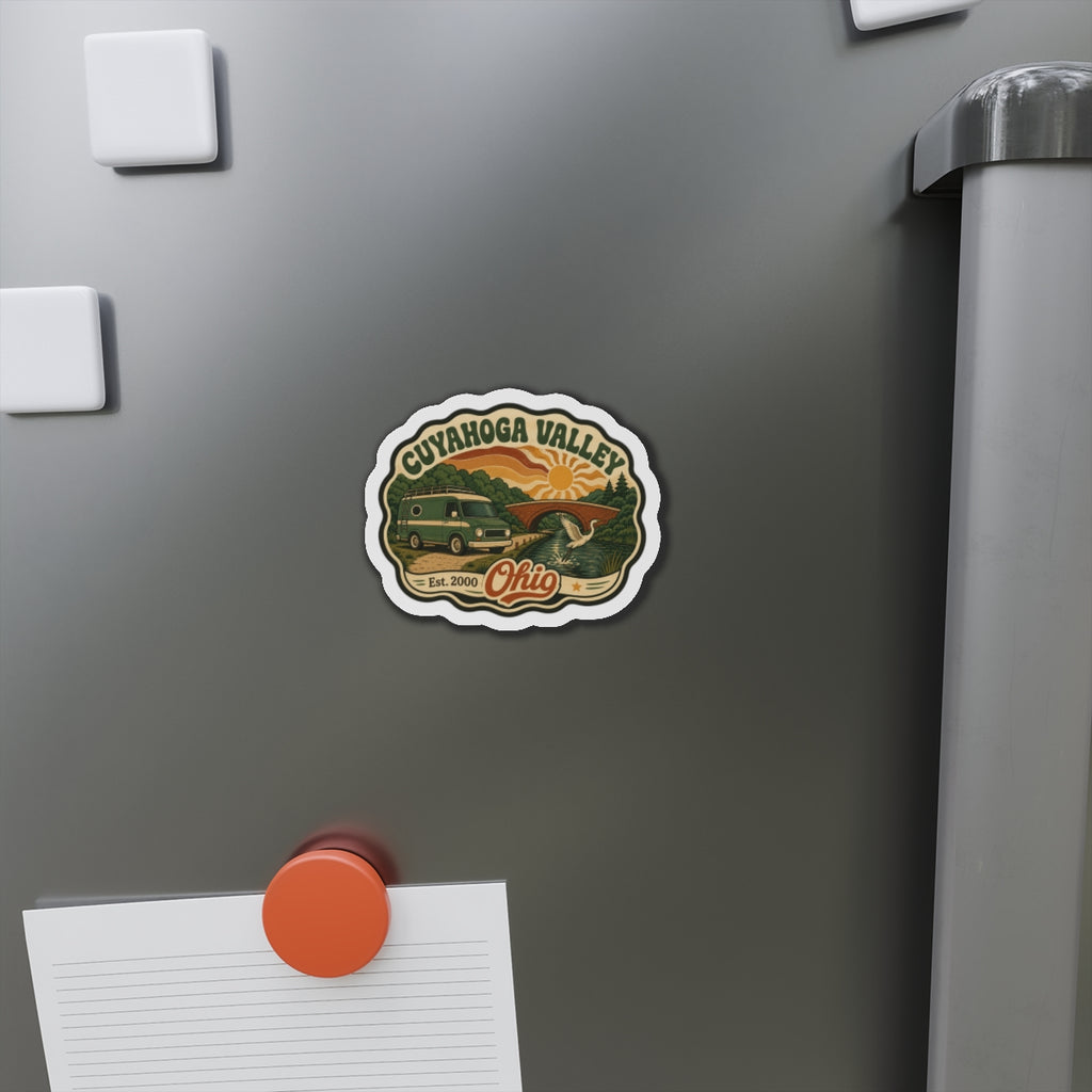Die-cut fridge magnet on refrigerator door with Cuyahoga Valley logo and retro camper van.