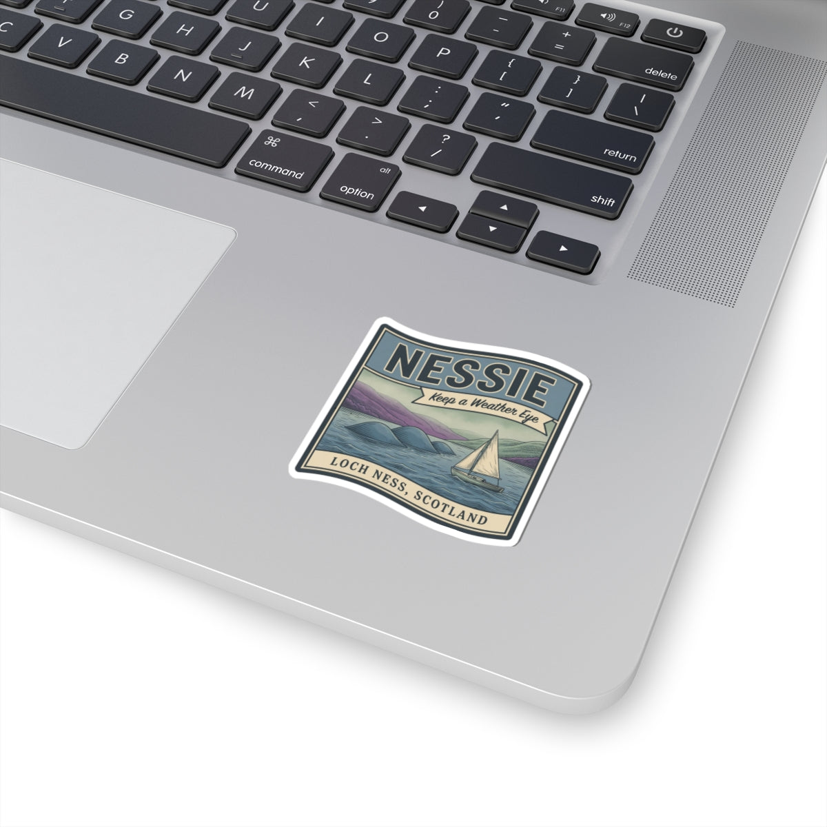 Vintage Nessie sticker with sailboat, 'Loch Ness, Scotland' text, on laptop