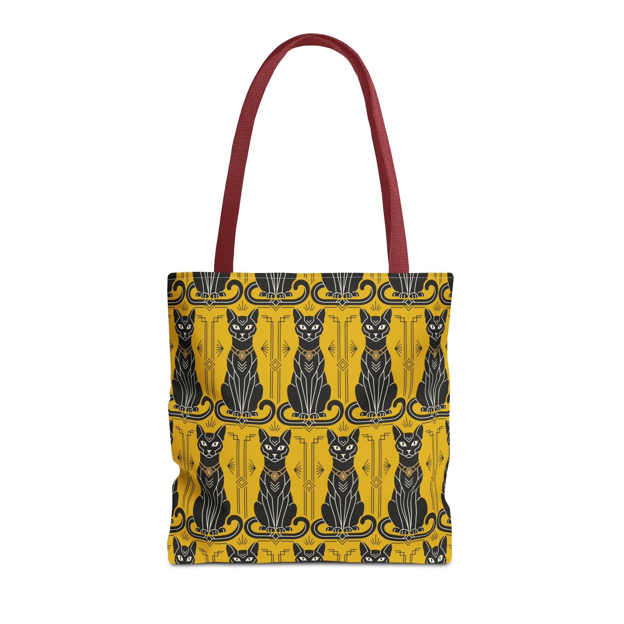 Tote bag with repeating cat silhouettes on yellow with blue accents, burgundy handles.
