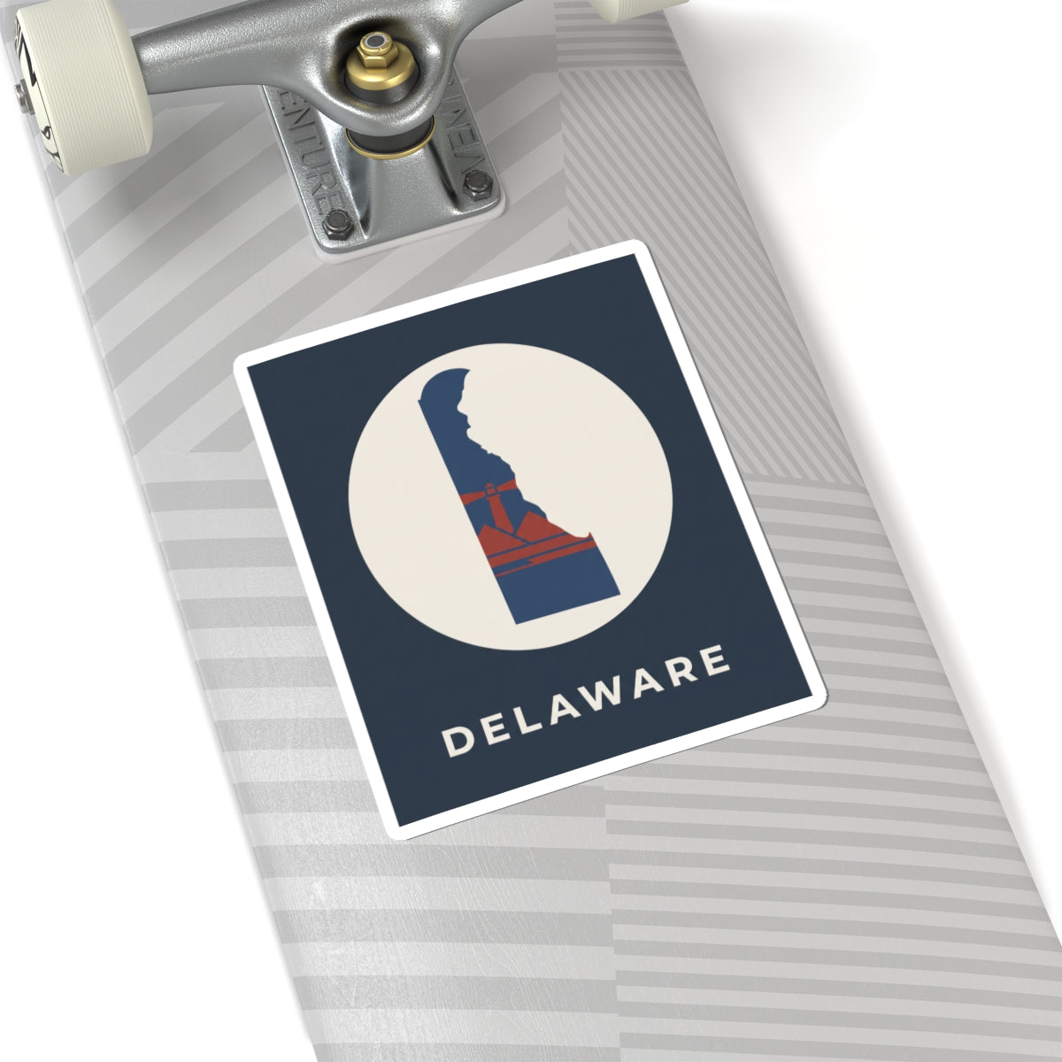 Kiss-cut Delaware sticker on a luggage tag, blue/red state silhouette in a white circle