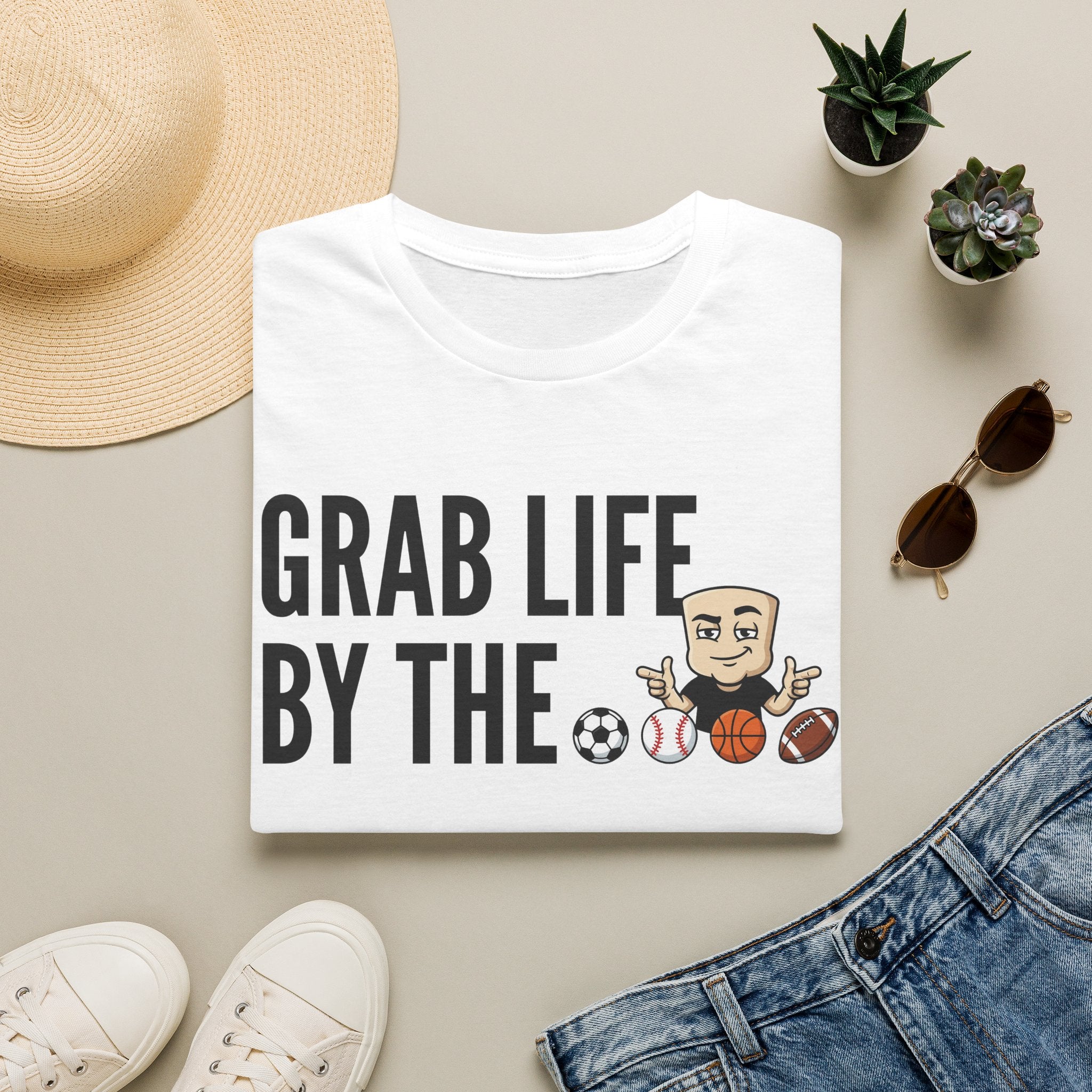White T-shirt with “GRAB LIFE BY THE” sports ball graphic and cartoon coach