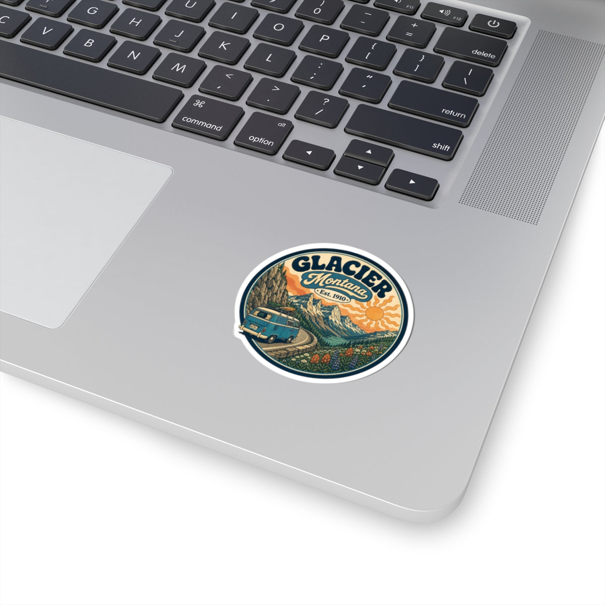 Round Glacier vintage camper van sticker, white border, on laptop