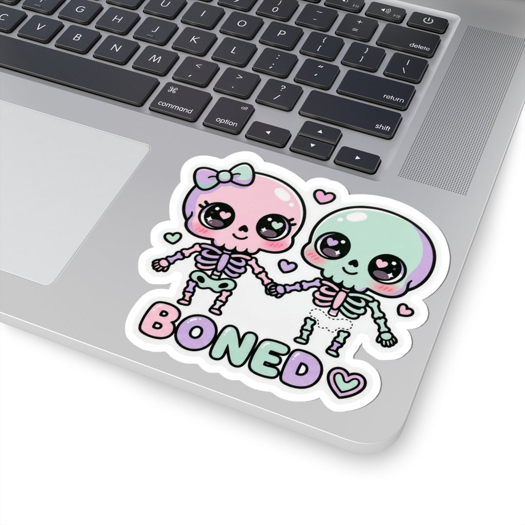 Pastel skull couple sticker with 'BONED' text, bow headband, and heart details