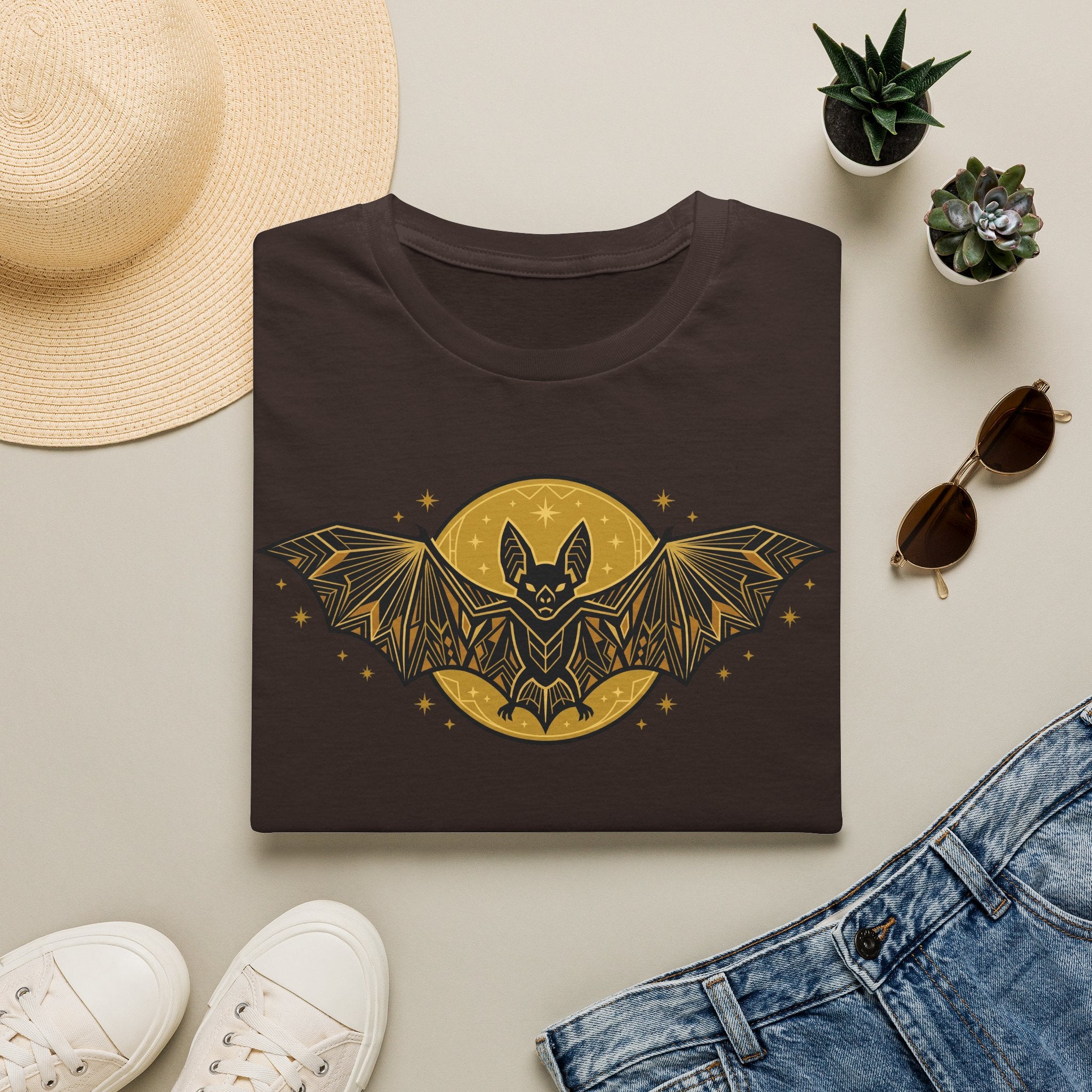 Dark brown graphic T-shirt with gold bat moon and winged stars
